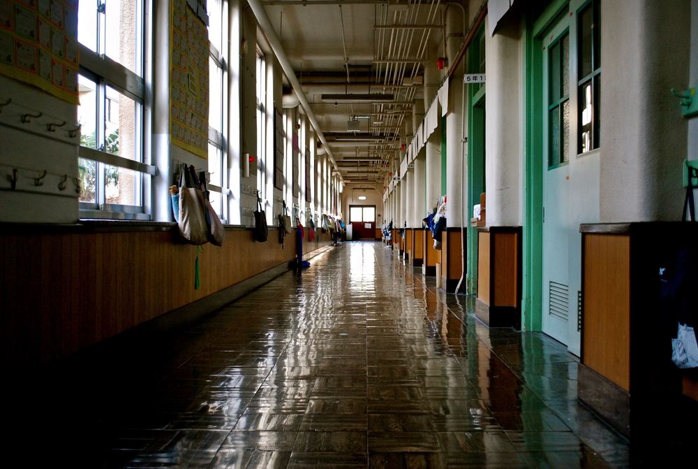 A darkened school corridor.